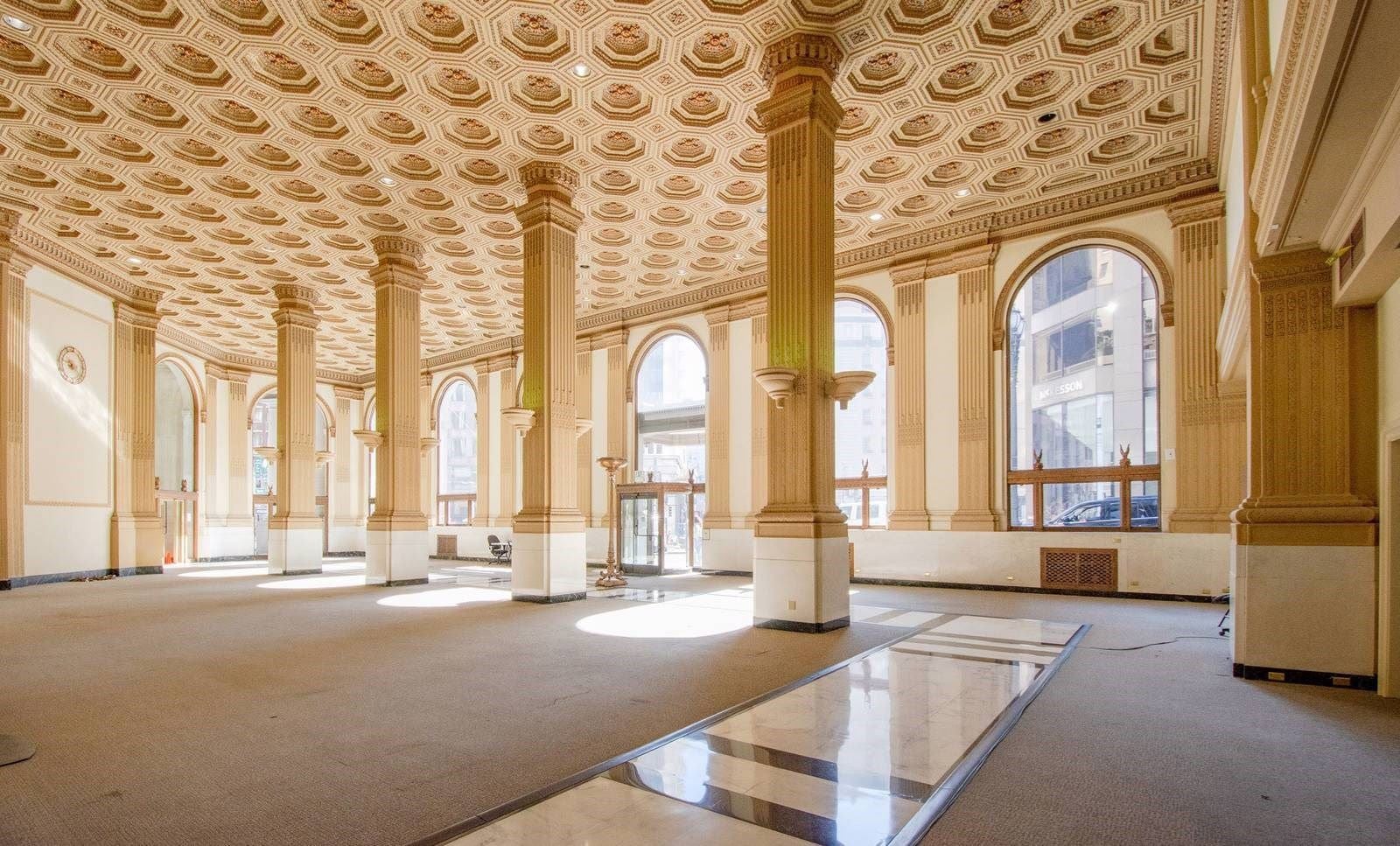 Sunlit historic San Francisco venue with soaring columns and an ornate coffered ceiling